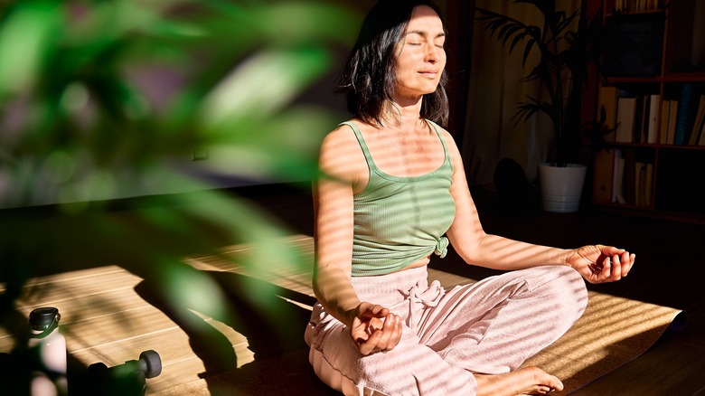 sunlit woman meditating