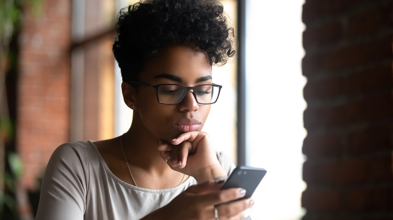 woman looking at phone