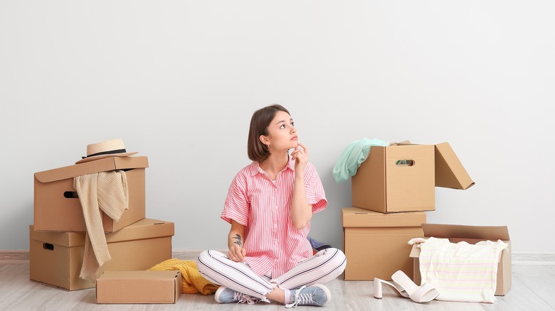 woman with boxes and clothing items