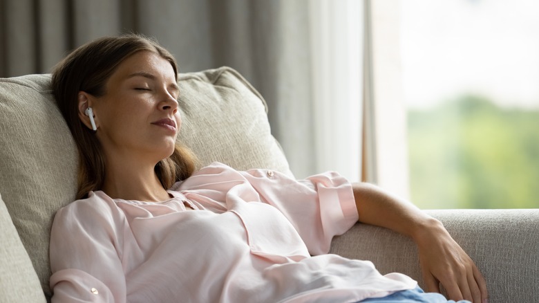 Woman sleeps on couch