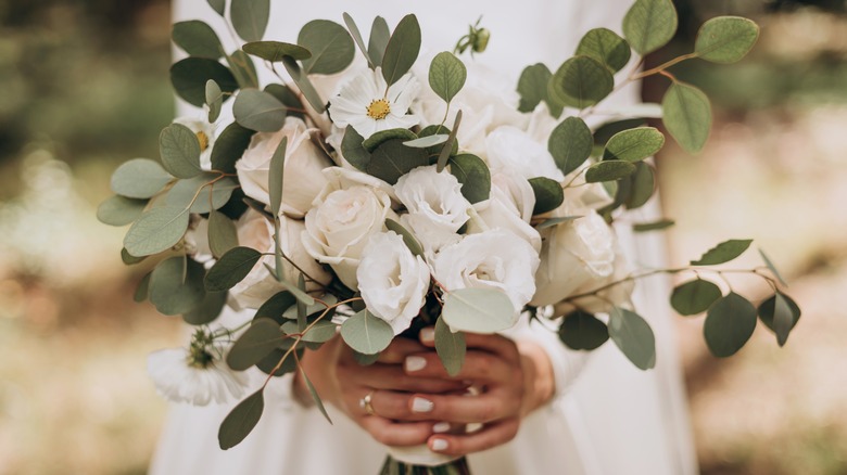 bride in white dress holding bouquet