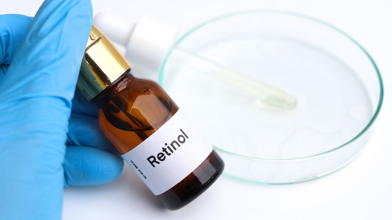 blue glove holding retinol