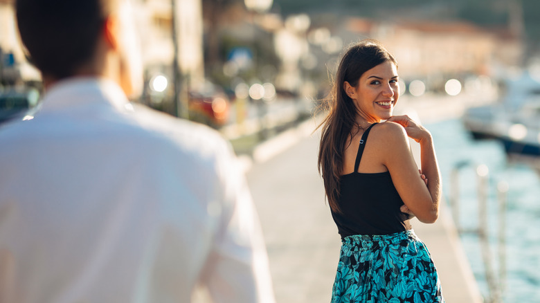 Smiling woman looking back at guy