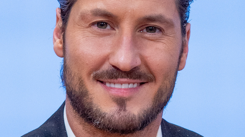 Val Chmerkovskiy wearing suit with wide smile