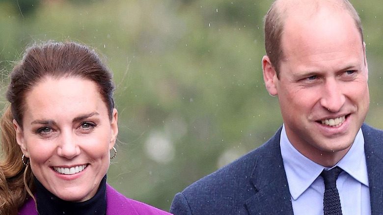 Prince William and Kate Middleton smiling at an event.