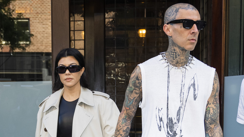 Kourtney Kardashian and Travis Barker holding hands