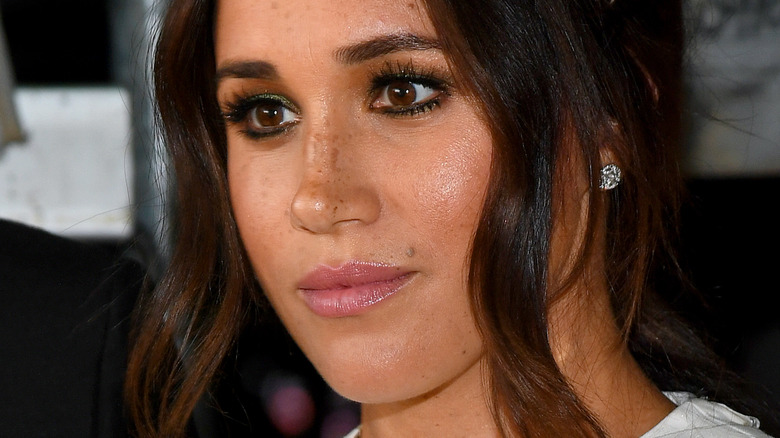 Meghan Markle with serious expression in side profile