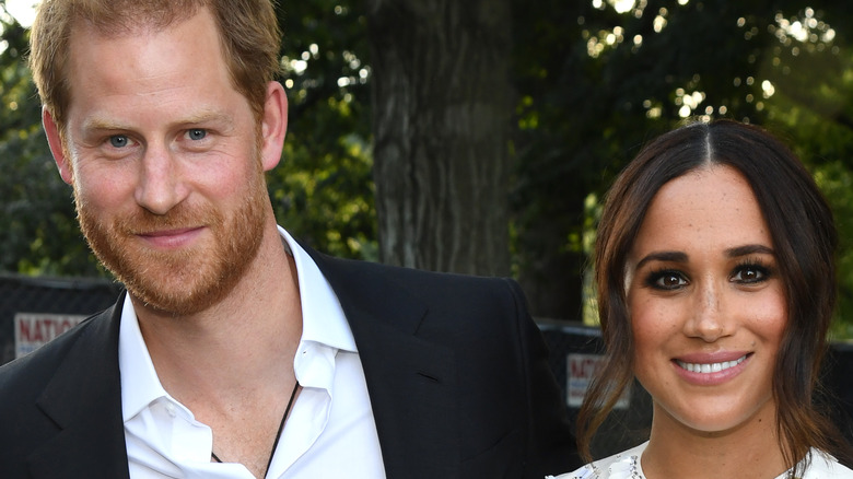 Prince Harry and Meghan Markle smile for the camera.