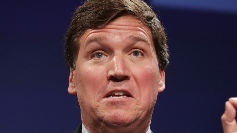Tucker Carlson speaking to an audience