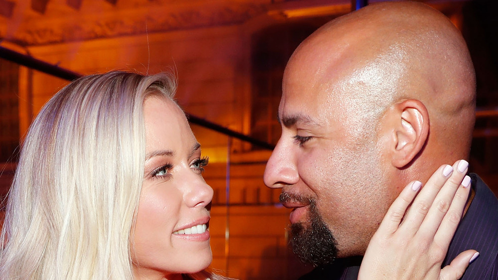 Kendra Wilkinson and Hank Baskett looking at each other