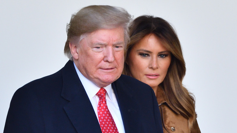 Melania Trump walks behinds Donald Trump