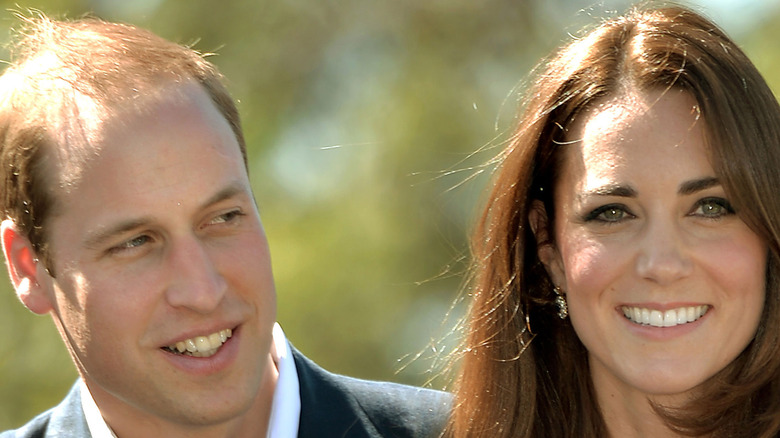 Prince William and Kate Middleton smiling at an event.