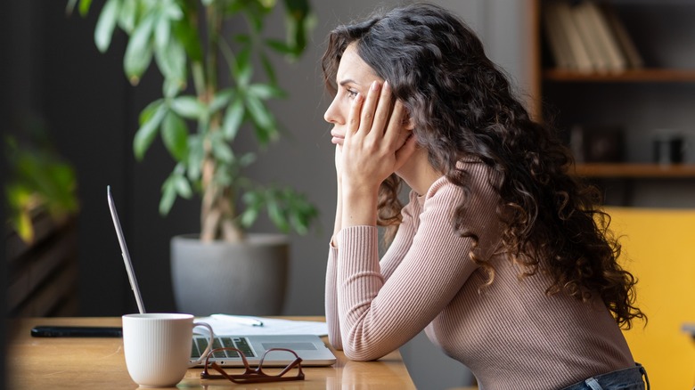 frustrated woman sitting at desk