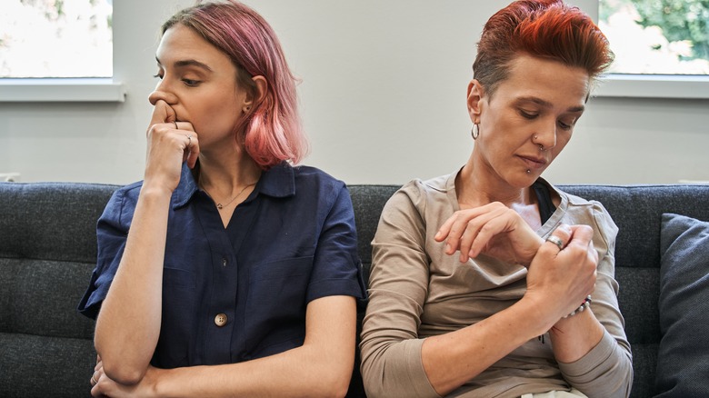 Female couple ignoring each other