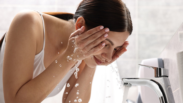 woman washing her face