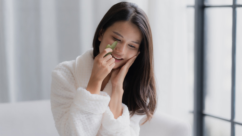 woman using gua sha