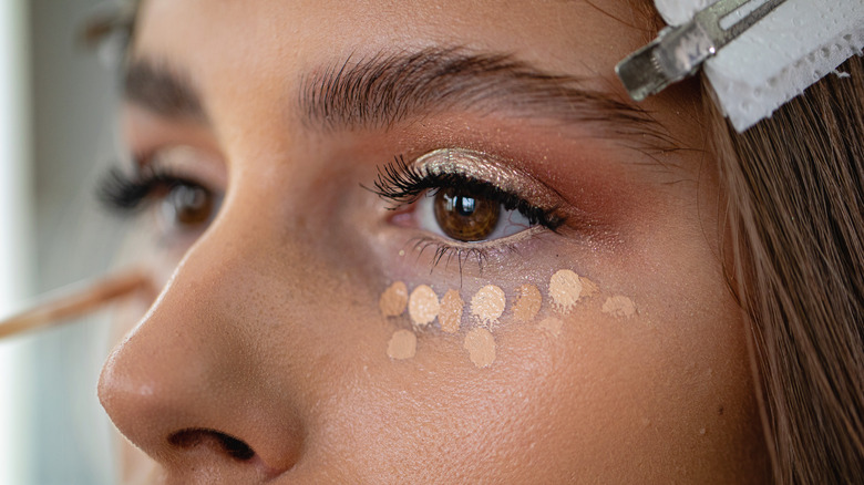 Woman having her makeup done