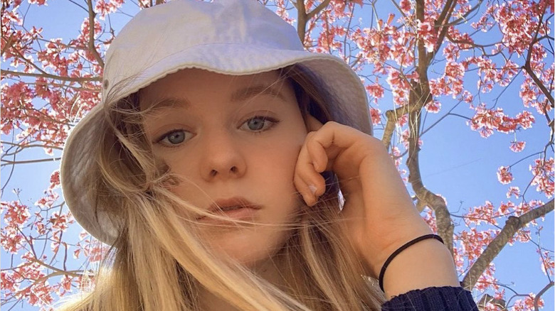 Isabella Crovetti near cherry blossoms