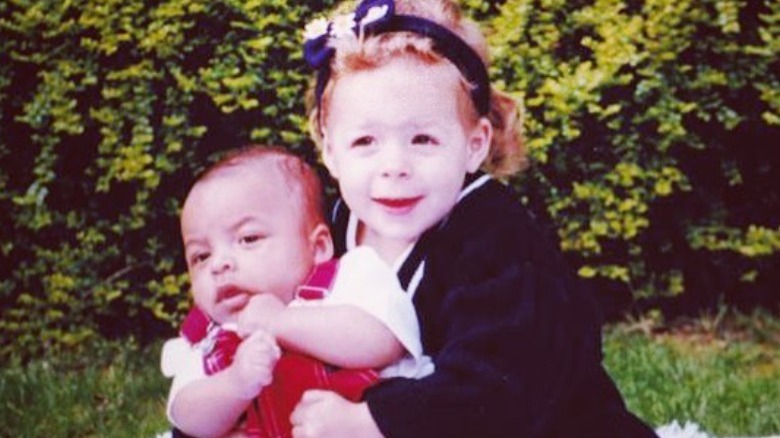 Young Isabella Cruise holding baby Connor Cruise