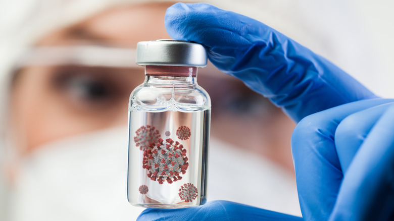 Scientist holds vial