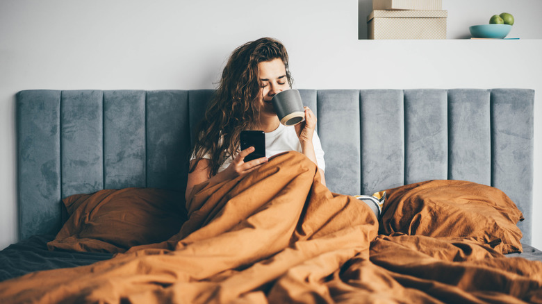 Woman on phone in bed