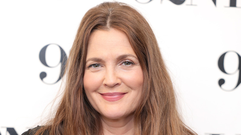 Drew Barrymore smiling while posing at an event