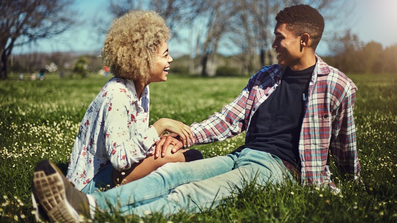 couple laughing in the grass