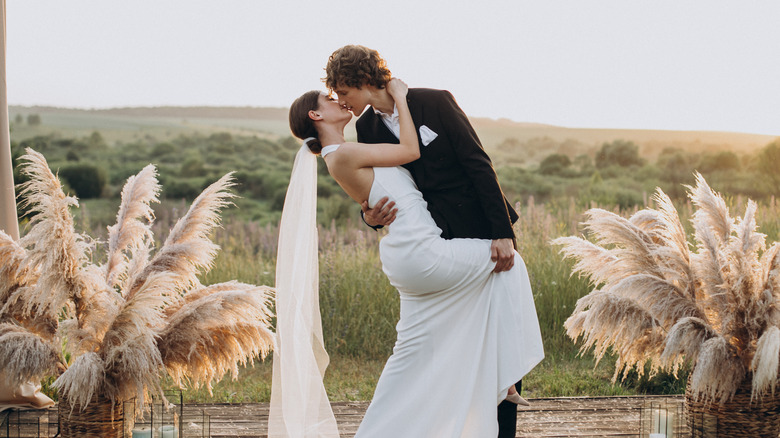 Bride and groom kiss at the altar