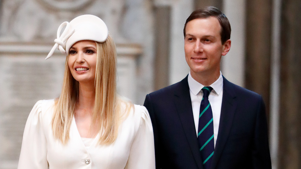 Ivanka Trump in a white hat with Jared Kushner