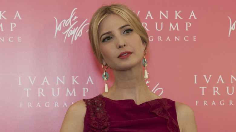 Ivanka Trump posing in a dark red dress at New York.