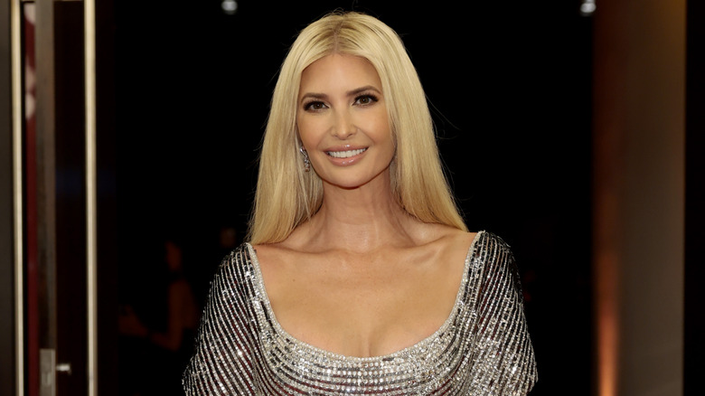 Ivanka Trump posing in a glittery silver gown
