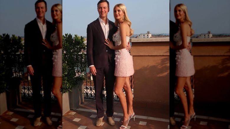 Ivanka Trump smiling in a black dress next to Jared Kushner.