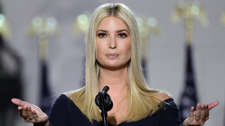 Ivanka Trump holds out her hands onstage
