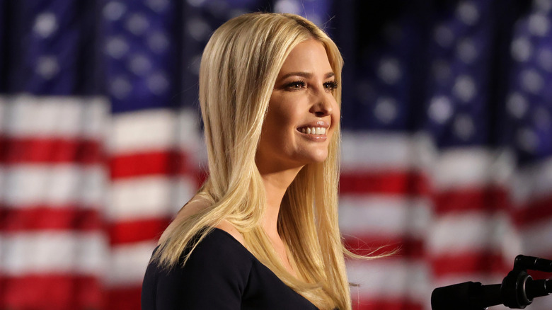 Ivanka Trump smiles in front of American flag