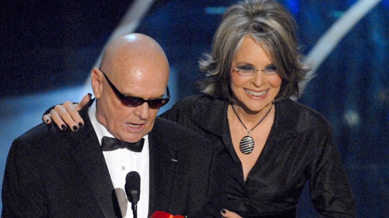 A bald Jack Nicholson and a smiling Diane Keaton with her hand on his shoulder while presenting at the Oscars