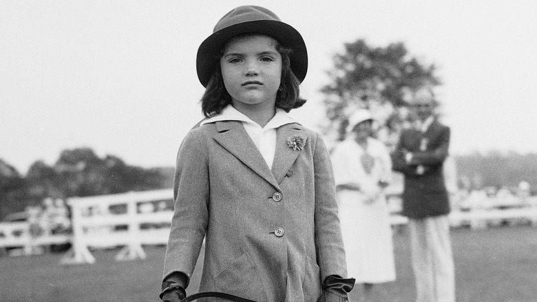 Jackie Kennedy smiling on couch