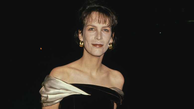 Jamie Lee Curtis smiling at the Golden Globes in 1990