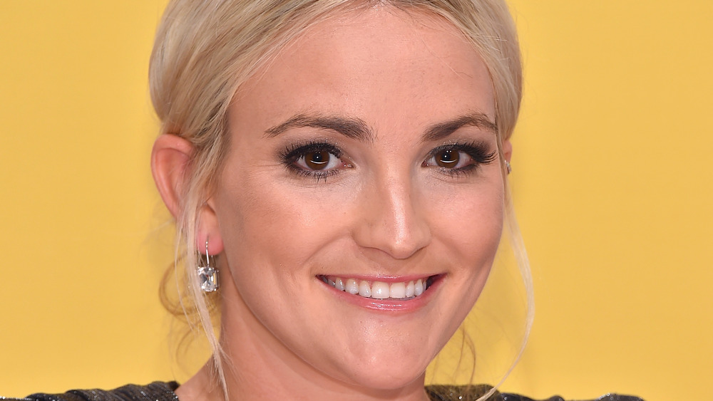 Jamie Lynn Spears hair up smiling with diamond earrings