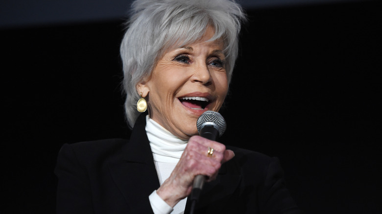 Jane Fonda smiling with a microphone