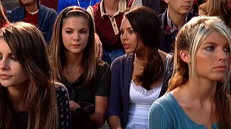 Janel Parrish sitting on bleachers in an episode of "The OC"
