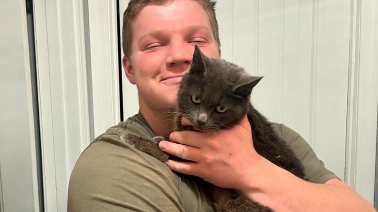 Robert Garrison Brown holding gray cat