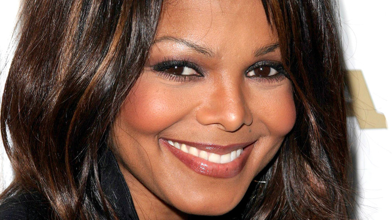 Janet Jackson grinning on the red carpet