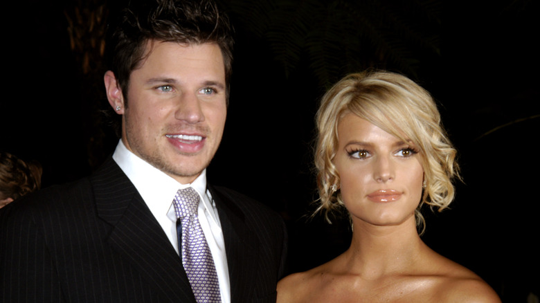 Nick Lachey in a suit with Jessica Simpson.