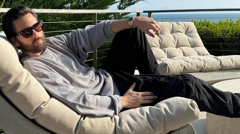 Scott Disick lounging on a deck, May 2024