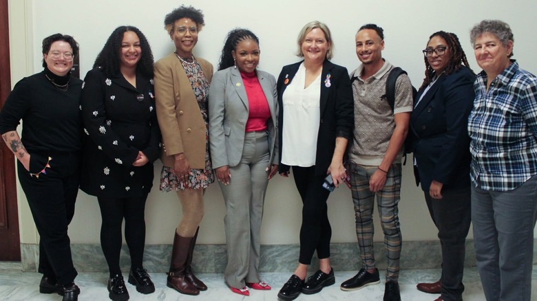 Jasmine Crockett with the team at GLSEN inside hallway.