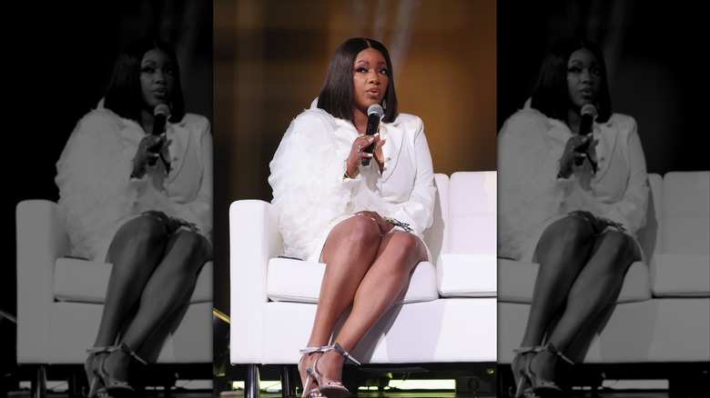 Jasmine Crockett sitting on a white couch