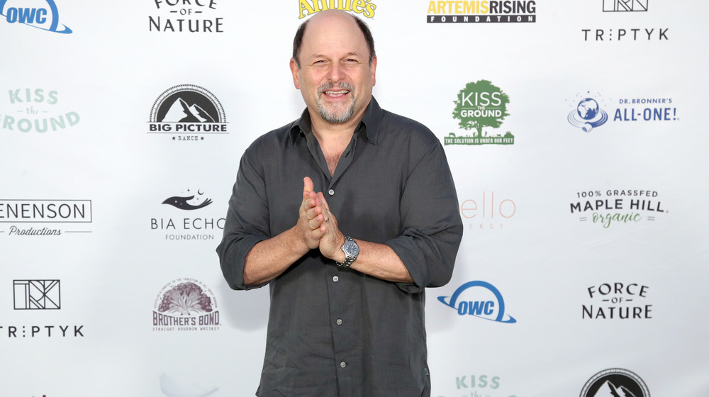 Jason Alexander smiling for cameras