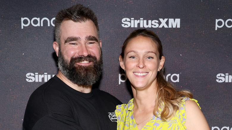 Jason Kelce and Kylie Kelce cozied up for a picture in front of a black background.