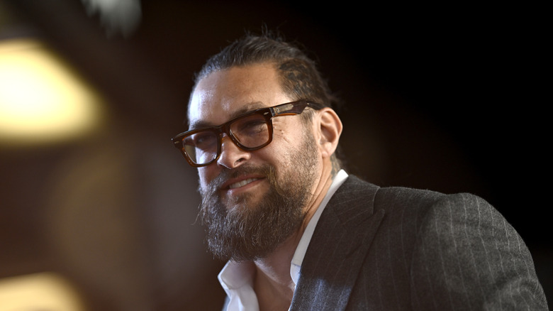 Jason Momoa smiling in glasses