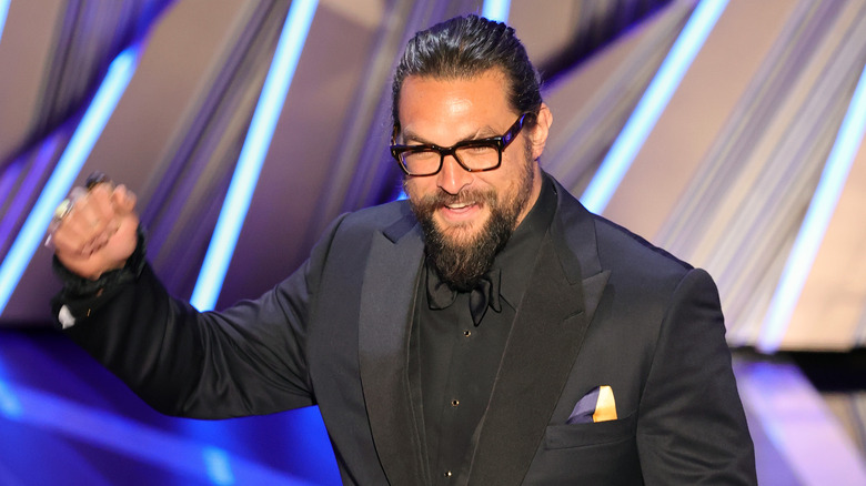 Jason Momoa with his fist in the air